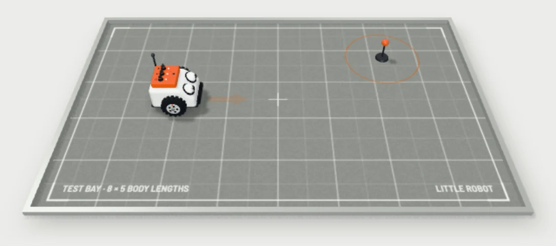 The little robot on its test bay, with an orange target peg a few body lengths away.